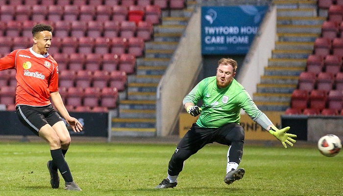 Deon Chesters scores for Red Alex Shirts past Ryan Briddon (1)