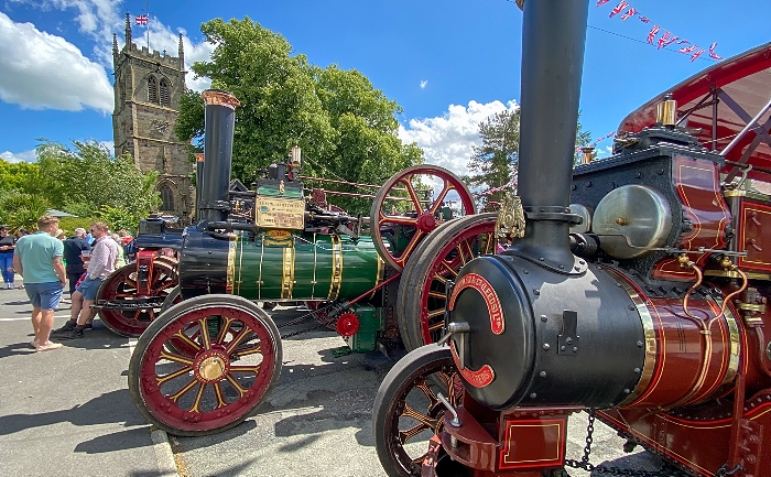 Steam traction engines outside The Swan Inn with Wybunbury Tower in the background