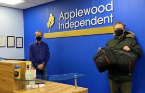 Nantwich firm Applewood Independent donates 12 laptops to school