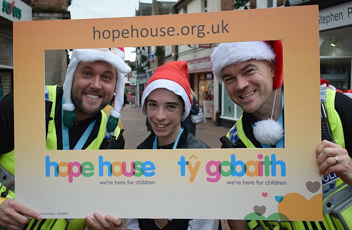 5 kilometre Santa Dash winner Ryan Harper-Griffiths poses with two Nantwich Police officers