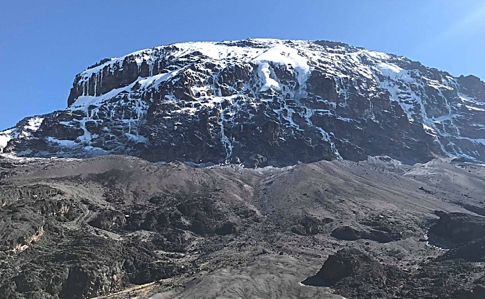 A view up towards the top of a snow-capped Mount Kilimanjaro