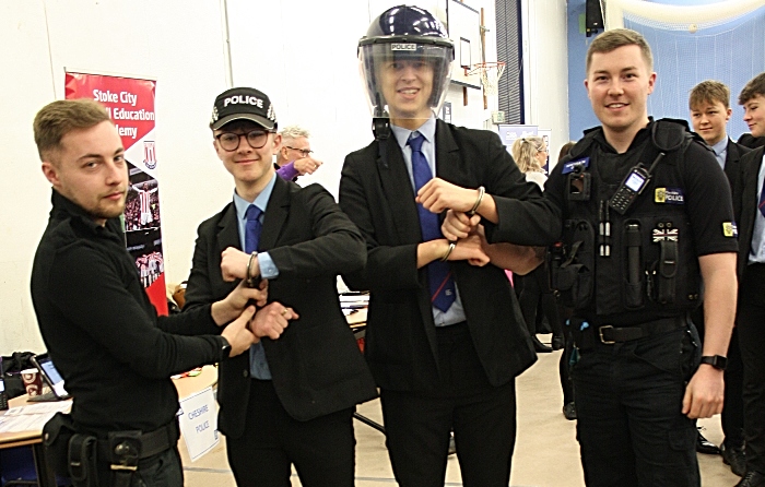 Ash Wood and Dan Owen from Cheshire Police give Harry Hassall and David Wright the experience of being handcuffed