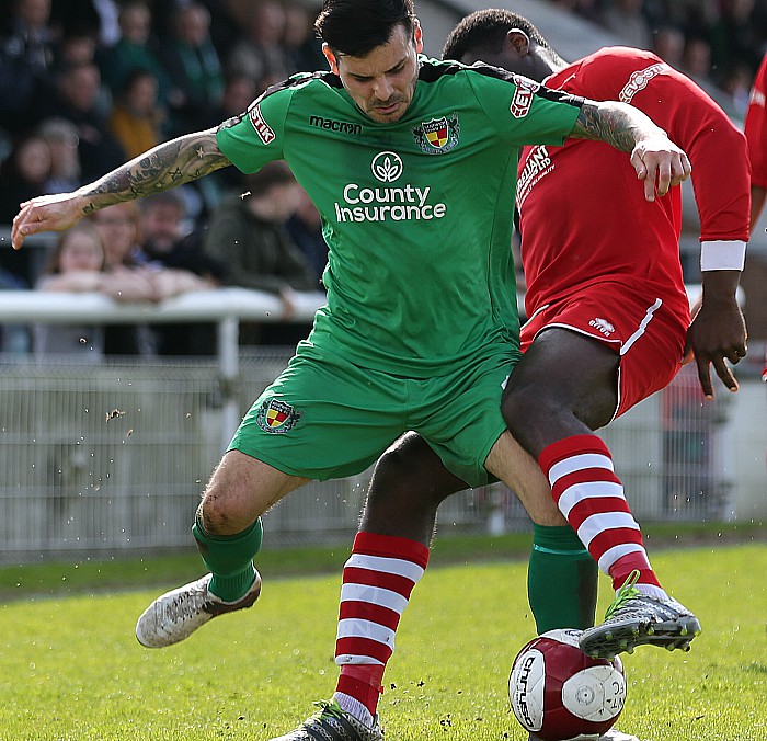 Assistant Manager-player Danny Griggs fights for the ball