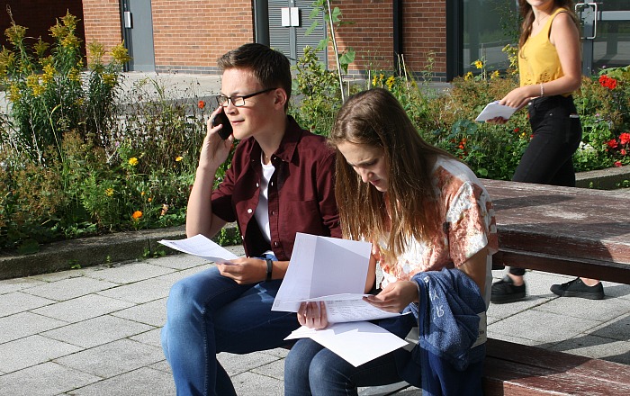 Ben Redfearn and Isabel Lloyd study their results and share the good news - GCSE results