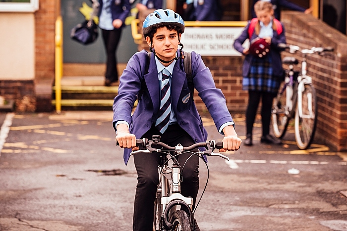 Boy cycling to school - transport and travel