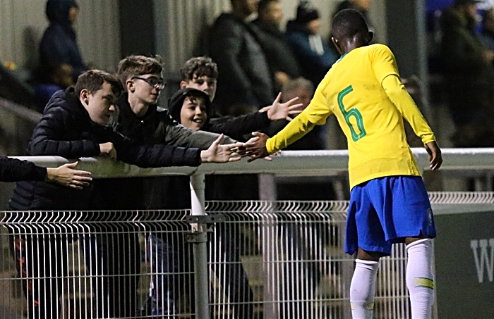 Brazil player Eduardo Pinto de Jesus meets fans during a break in the action