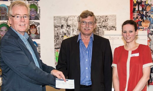 Chair of the Museum Trust, Nick Dyer (left), receives the cheque from Tim Ashworth as Museum Manager, Kate Dobson, looks on