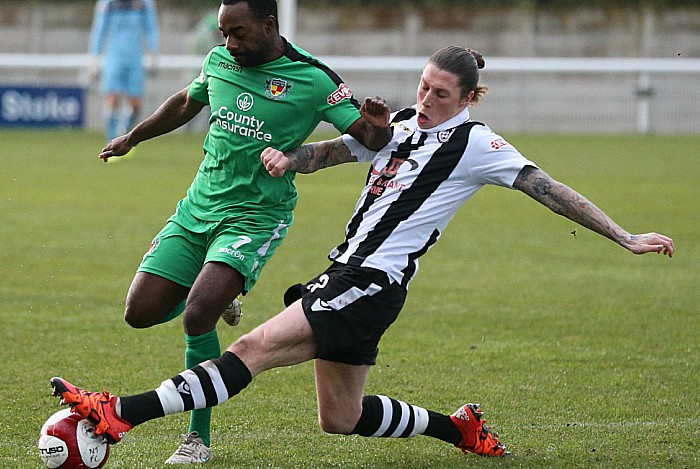 Coalville defender Lee Torr tackles the ball from Joe Mwasile