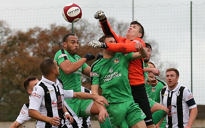 Coalville keeper Matt Coton clears the ball