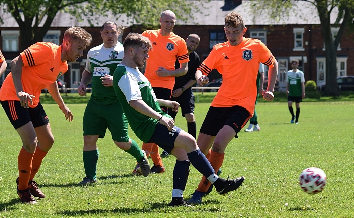 Cuddington player passes the ball under pressure from the Pirates (1)