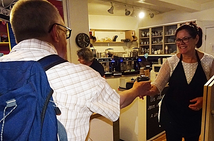 Customer Mark Ray receives his latte from Denise Lawson at Nantwich Bookshop and Coffee Lounge (1)