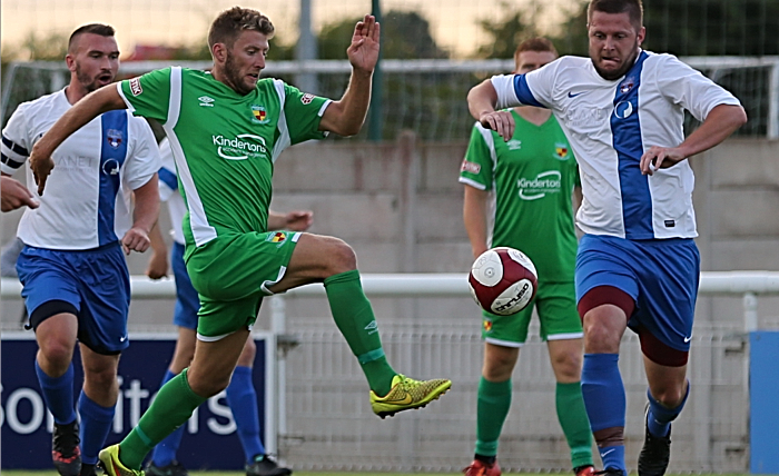 v Sandbach United - Danny Glover challenges for the ball (2)