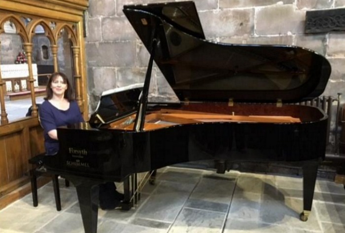 Dr Marie McKavanagh delighting St Mary's parishioners with a mini recital on their new grand piano