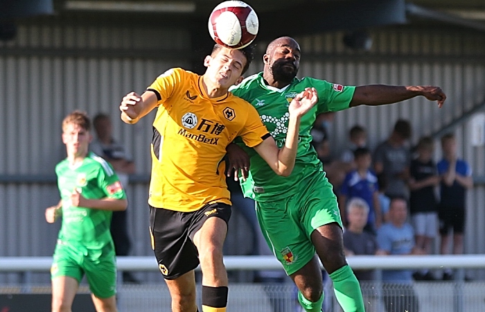 First-half - Joe Mwasile challenges for the ball (1)