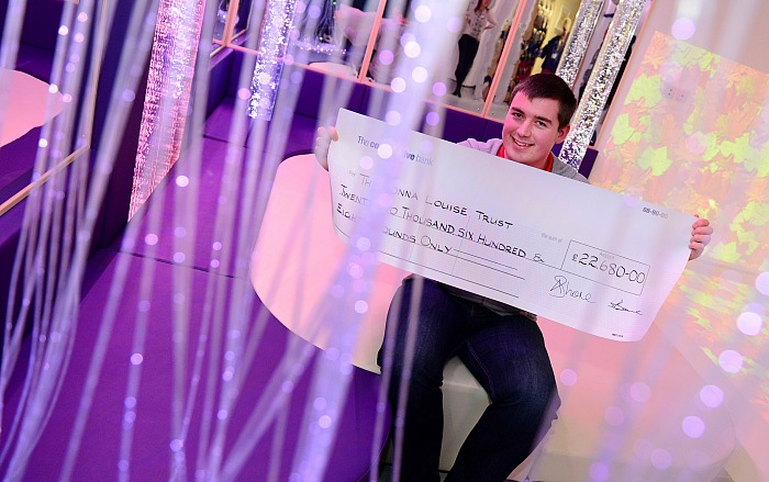 Graham Witter with his cheque in the fully refurbished sensory room