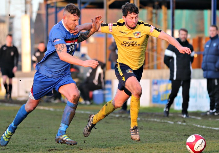 Harry Clayton eyes the ball under pressure in the second-half