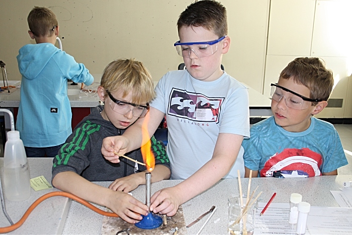 Elias Sumner (Stapeley Broad lane), Luke Downey and Ethan Shell use flame tests to help solve the Crime Scene Investigation.