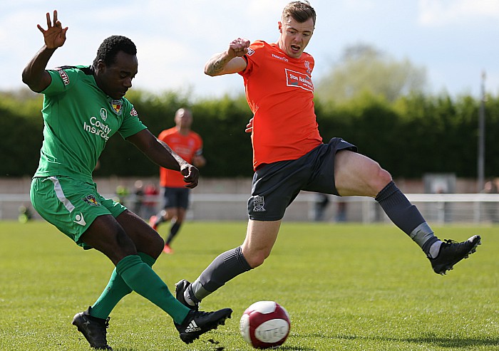 Joe Mwasile crosses the ball under pressure