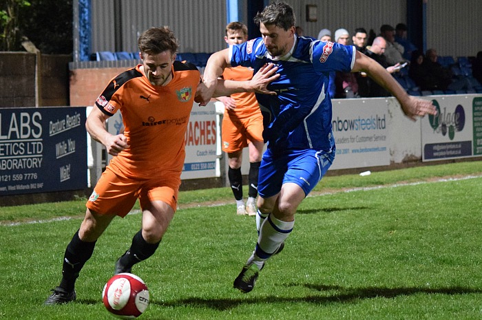 Josh Hancock fends off a Halesowen player