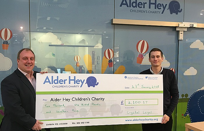 Left, Tony Shields MD of Crystal Legal hands the cheque over to Allan Eves from Alder Hey