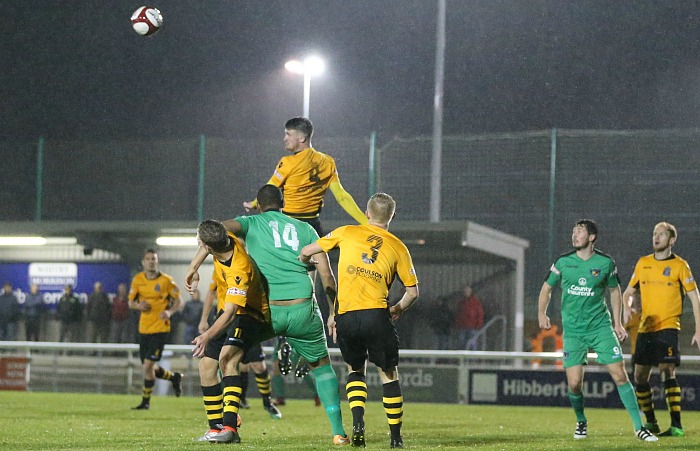 Marine midfielder Adam Hughes heads the ball clear