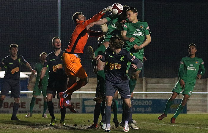 Matlock Town keeper Richard Walton punches the ball clear