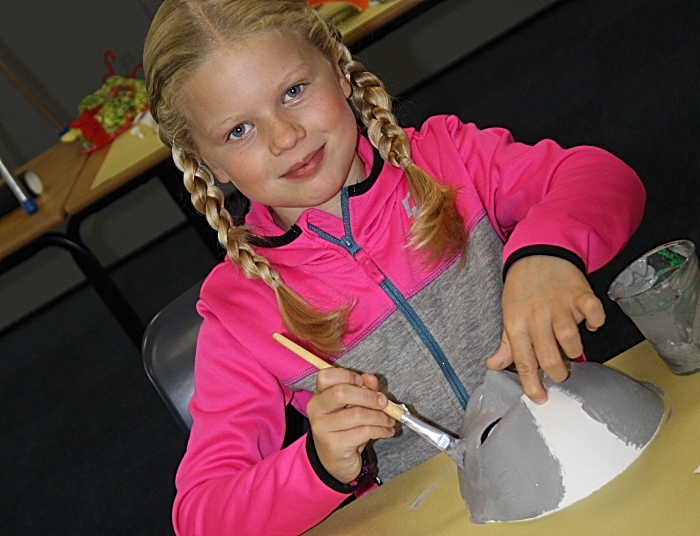 Mya Marshall cheerfully paints her mask