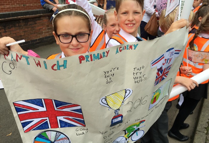 Nantwich Primary Academy pupils with posters watching tour of Britain