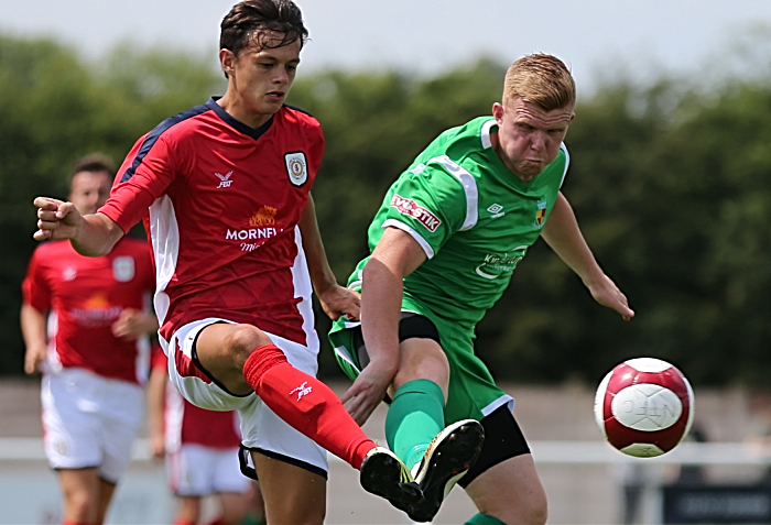 Perry Ng and Danny Glover challenge for the ball (1)