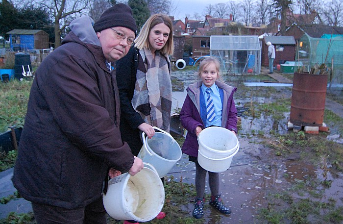 Allotments chair Phil Williams, MP Laura Smith, and young gardener Lottie Nichols, 9