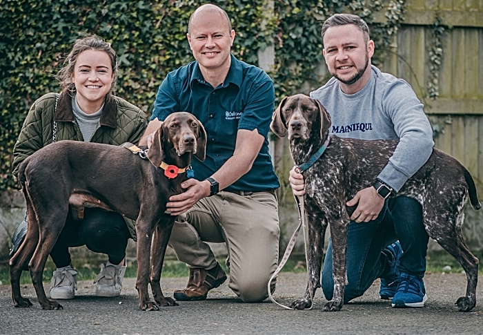 Rebecca Vickers and Alex McGreal and vet Charlie Sale(centre) with Cola (left) and the couple's other pointer Ronnie