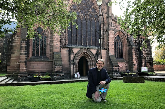 Rev Mark Hart at St Mary's Church and Forget Me Not flower