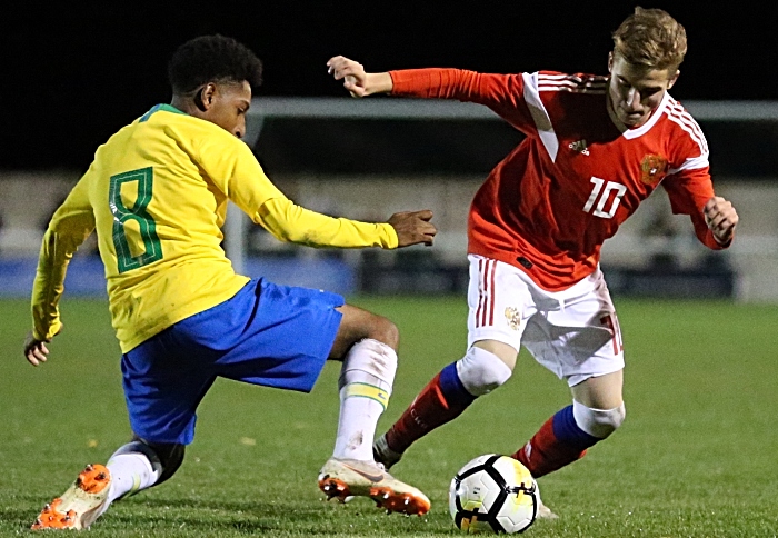 Russias Petrov Maksim controls the ball under pressure from Brazils Talles Macedo Toledo Costa