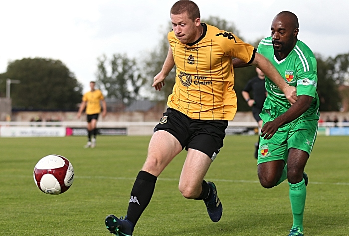 Second-half - Joe Mwasile challenges for the ball (1)