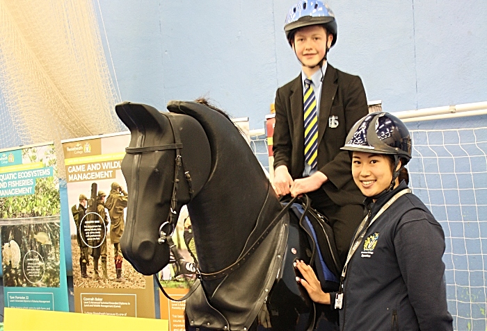 Careers - Sophie Chui Chi Lai, a technician from Reaseheath College Equestrian department, prepares to let Jack Marshall experience the thrills of horse riding