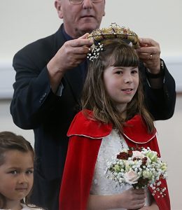 St. Mary's Wistaston Rector Mike Turnbull places the crown on this year's Rose Queen Charlotte Shaw (1)