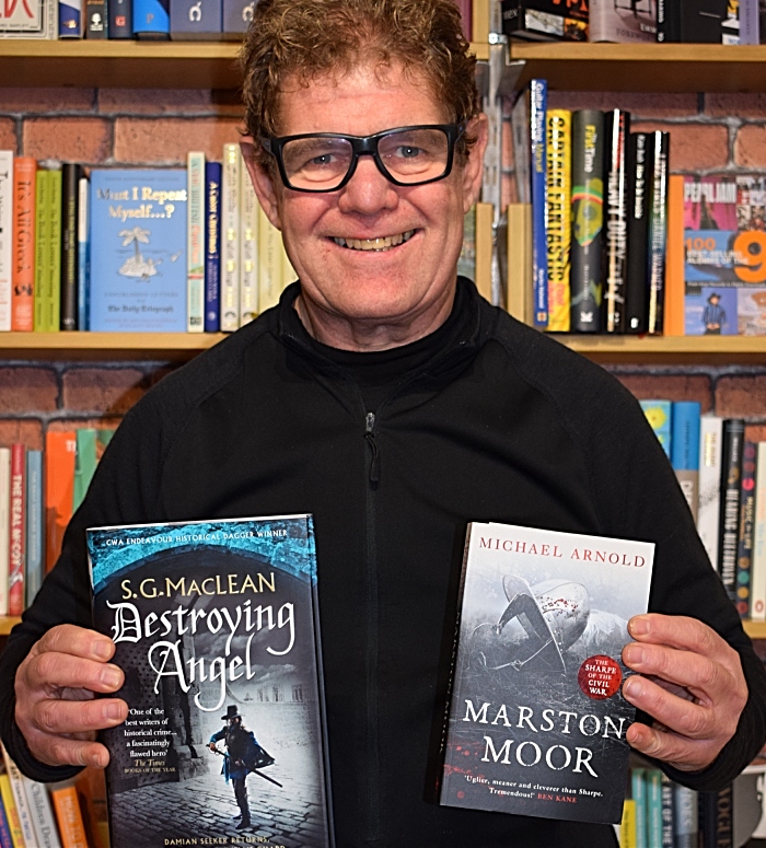 Steve Lawson from Nantwich Book Shop & Coffee holds books from authors attending the event (1)