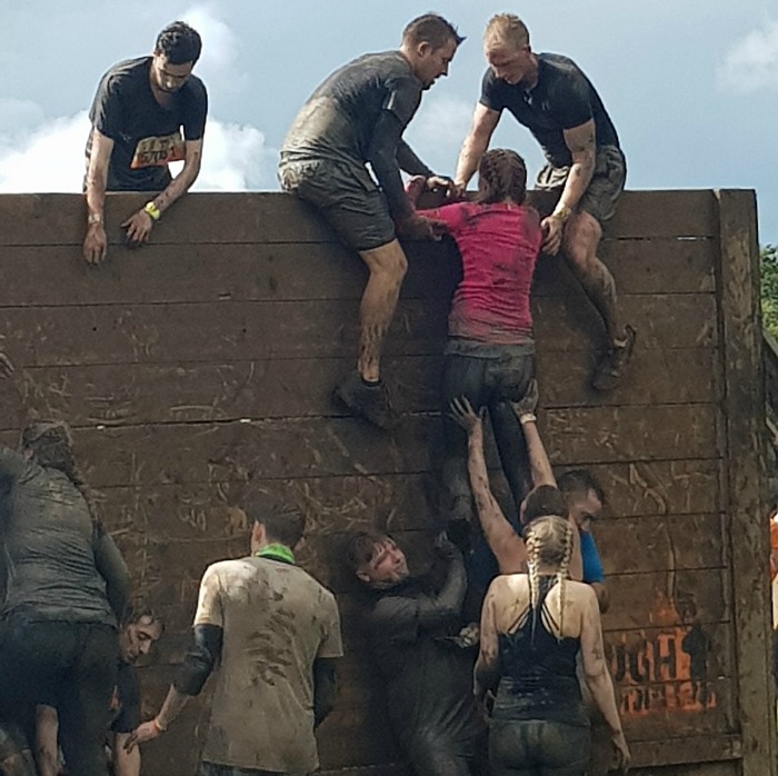 The Hibberts solicitors team helping one another over the obstacles