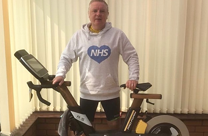 Tim Bowker and his indoor bicycle after completing his ride (1)