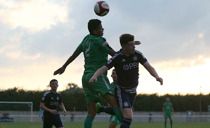 Troy Bourne wins a header in the first half close to sunset