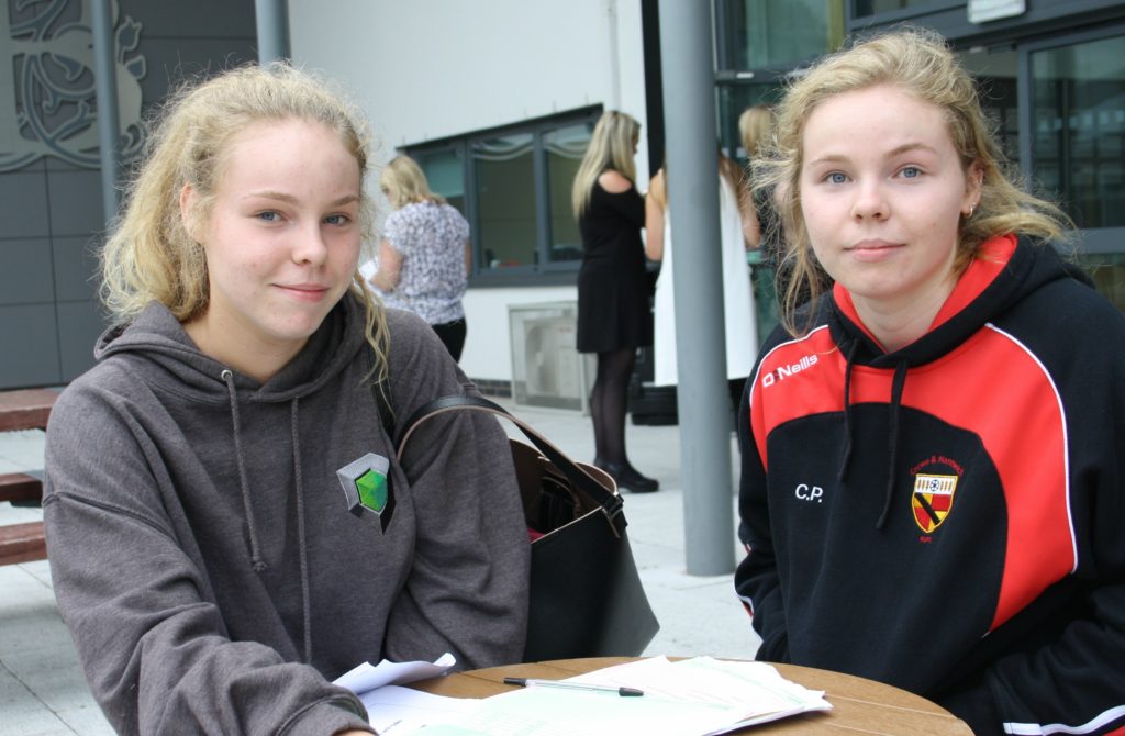 Twins, Anna and Charlotte Harding sit and assess their results