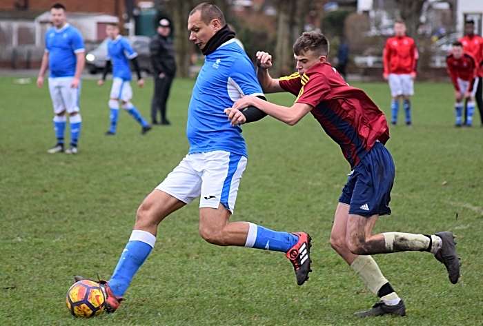 Willaston White Star player keeps the ball under pressure (1)