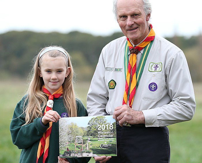 Wistaston Scout Group l-r Emma Bowkett (Cub) and Gerald Newbrook (Honorary President) with the 2018 Wistaston Calendar