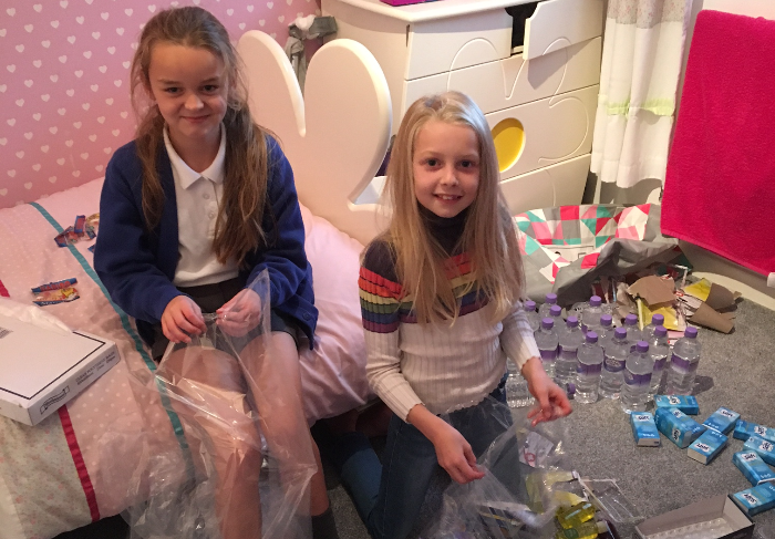 daisy and mia bagging up all goods collected