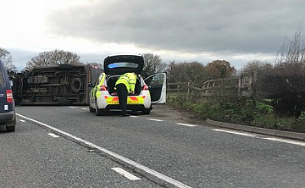 police on scene of overturned car A51 Reaseheath