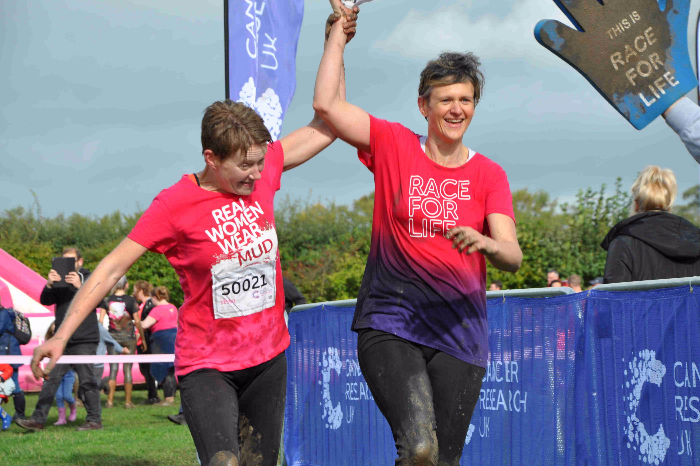 runners in pretty muddy sea of pink event